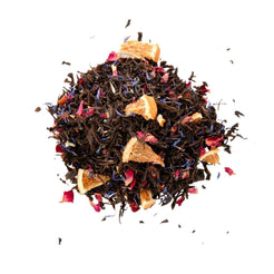 A close-up image of loose leaf tea with a mix of black tea, blue cornflowers, orange peel, rose petals, and rosehip shells.